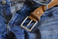 Close-up of blue jeans with a brown leather belt Royalty Free Stock Photo