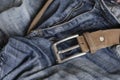 Close-up of blue jeans with a brown leather belt Royalty Free Stock Photo