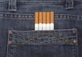 Close up of a blue jeans pocket with cigarettes