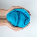 Close-up of blue merino wool ball in hands Royalty Free Stock Photo