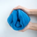 Close-up of blue merino wool ball in hands Royalty Free Stock Photo