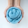 Close-up of blue merino wool ball in hands Royalty Free Stock Photo