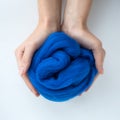 Close-up of blue merino wool ball in hands Royalty Free Stock Photo