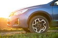 Close up of blue off road car on green grass. Traveling by auto, adventure in wildlife, expedition or extreme travel on a SUV Royalty Free Stock Photo