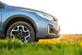 Close up of blue off road car on green grass. Traveling by auto, adventure in wildlife, expedition or extreme travel on a SUV Royalty Free Stock Photo
