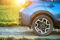 Close up of blue off road car wheel on gravel road. Traveling by auto, adventure in wildlife, expedition or extreme travel on a Royalty Free Stock Photo