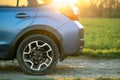 Close up of blue off road car wheel on gravel road. Traveling by auto, adventure in wildlife, expedition or extreme travel on a Royalty Free Stock Photo