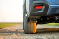 Close up of blue off road car wheel on gravel road. Traveling by auto, adventure in wildlife, expedition or extreme travel on a Royalty Free Stock Photo