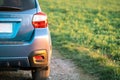 Close up of blue off road car wheel on gravel road. Traveling by auto, adventure in wildlife, expedition or extreme travel on a Royalty Free Stock Photo