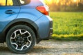 Close up of blue off road car wheel on gravel road. Traveling by auto, adventure in wildlife, expedition or extreme travel on a Royalty Free Stock Photo