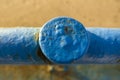 Close-Up of Blue Painted Metal Post with Weathered Texture Royalty Free Stock Photo