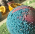 Close up of blue and pink bath bomb over oranges