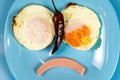 Close-up on a blue plate of a spicy breakfast smiley omelette with pepper