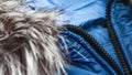 Close-up on blue puffer jacket. women winter fashion concept