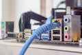 Close up of Blue RJ45 UTP LAN Cable connect to Naked PC Mainboard (Cryptocurrency Mining Rig) Royalty Free Stock Photo