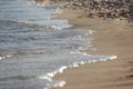 Close up blue sea water waves on sand beach Royalty Free Stock Photo