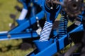 Close-up of a blue seeder for agricultural machinery. Photo of a tube for feeding grain