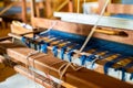 Close Up of Blue Silk on the Weaving machine and Thai traditional Silk. Weaving loom for homemade Silk textile Royalty Free Stock Photo