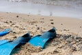 Close up blue snorkeling fins on the beach. Royalty Free Stock Photo