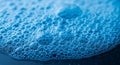 Close-up of blue soap bubbles on a surface. The bubbles vary in size, creating a dense Royalty Free Stock Photo