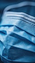 A close up of a blue surgical mask on top of some fabric, AI Royalty Free Stock Photo