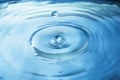 Close up blue water drop splash on water surface. Royalty Free Stock Photo