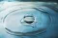 Close up blue water drop splash on water surface. Royalty Free Stock Photo