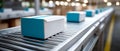 Close-up of blue and white boxes moving on a conveyor belt in a modern warehouse or packaging facility with blurred background Royalty Free Stock Photo