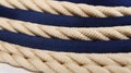 a close up of a blue and white rope on a white tablecloth with a white background and a black and white stripe on the bottom of Royalty Free Stock Photo