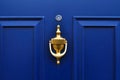 Close up of blue wooden door of home with eyehole