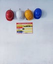 Close up Blue, yellow, white and red hard safety helmet hats for safety project as engineering or project worker place on hospital Royalty Free Stock Photo