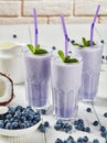 Close-up of blueberry frothy milkshake, top view