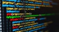 Close-up blurred view of colorful computer code on a dark screen programming and technology concept Royalty Free Stock Photo