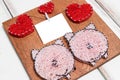 Close - up of the Board with nails wound with threads in the form of hearts and pigs and a piece of paper on a thread