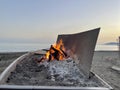 close-up of a boat on the beach with a barbecue for cooking sardines. typical food from Malaga Spain. sardine skewers