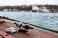 Close up of boat rope tied to nautical cleat hitch on boat