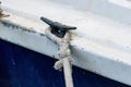 Close up of boat rope tied to nautical cleat hitch on boat