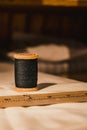 close up of bobbin and wooden ruler on top of old white fabric. Royalty Free Stock Photo