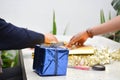 Close up of body part female hand preparing a gift at the table