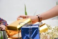 Close up of body part female hand preparing a gift at the table