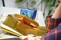 Close up of body part female hand preparing a gift at the table