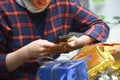 Close up of body part female hand preparing a gift at the table