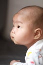 Close-up body parts baby infant chubby head dribble boy is suck eating his hands isolated background innocent pure happy smile