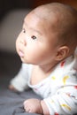 Close-up body parts baby infant chubby head dribble boy is suck eating his hands isolated background innocent pure happy smile