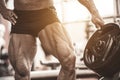 Close-up of bodybuilders muscular legs. Athlete man doing workout exercise in gym. Royalty Free Stock Photo