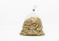 Close up of boiled peanuts in a cleared plastic bag for sale in the market, ready to eat, solated image on white background, front