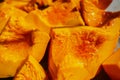 Close-up of boiled pumpkin pieces with honey. View from top. Old recipe for delicious and healthy food. Village treats.