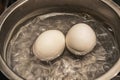 Close up boiling eggs in pot Royalty Free Stock Photo