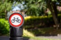 a close up of a bollard with a no cycling sign next to a cycle path Royalty Free Stock Photo