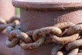 Close-up of bollards and iron chains on an old River barge. Securing the ship with a large chain. Old rusty vintage mooring Royalty Free Stock Photo